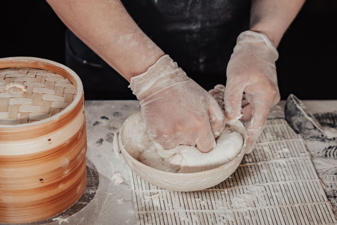 Hands shaping dough for mille-layer pastry